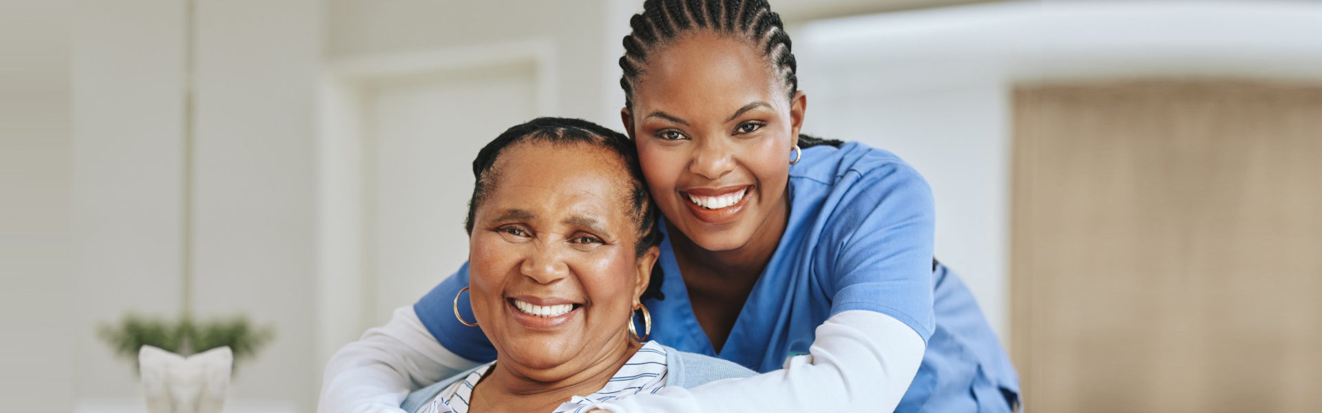 senior woman and caregiver smiling happily