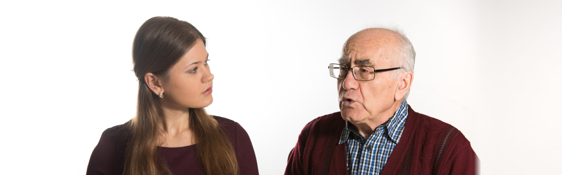 Young women helping senior men to pronounce sound and read book